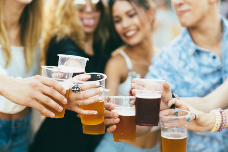 friends enjoying pints of beer at a fall festival