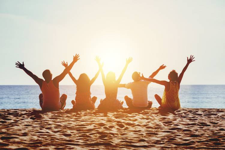 friends on beach at sunset