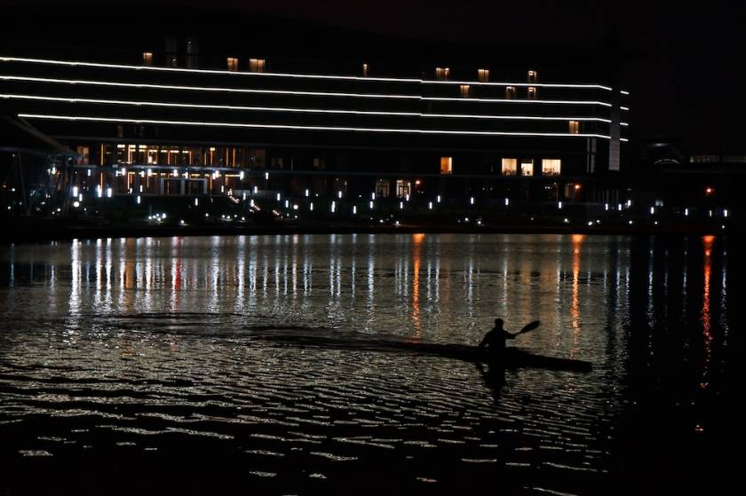 Person kayaking during moonlit paddleboarding tours