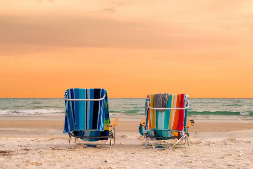 Beach chairs in the sand facing the water on Siesta Key